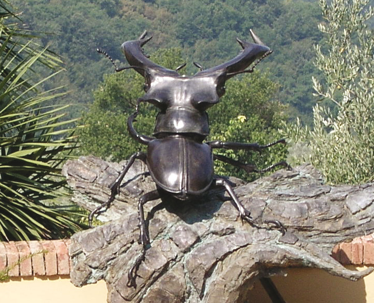 A monumental Stag Beetle on Bark - bronze sculpture